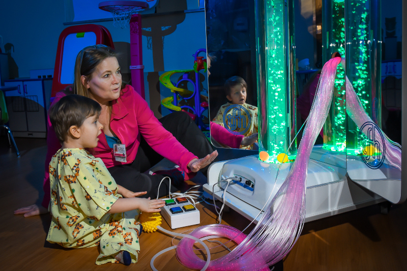 Child plays with bubble tower.
