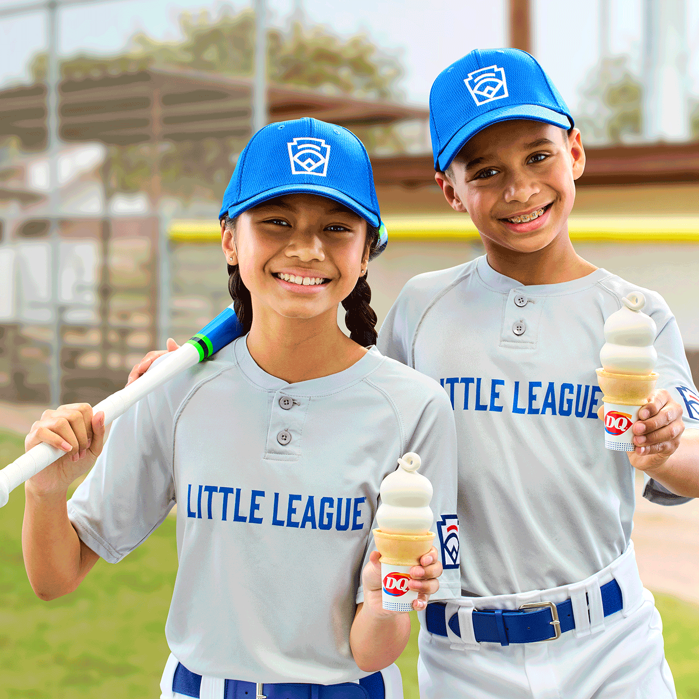 Two little league players holding DQ Cones
