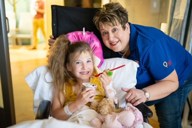 A volunteer posing with a hospital patient